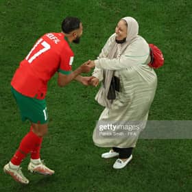 Sofiane Boufal of Morocco celebrates with his Mother after the team's 1-0 victory in the FIFA World Cup Qatar 2022 quarter final match between Morocco and Portugal at Al Thumama Stadium, December 2022 in Qatar. Pic: Patrick Smith - FIFA/FIFA via Getty Images.