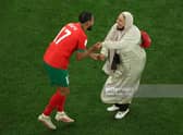 Sofiane Boufal of Morocco celebrates with his Mother after the team's 1-0 victory in the FIFA World Cup Qatar 2022 quarter final match between Morocco and Portugal at Al Thumama Stadium, December 2022 in Qatar. Pic: Patrick Smith - FIFA/FIFA via Getty Images.