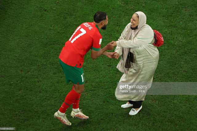Sofiane Boufal of Morocco celebrates with his Mother after the team's 1-0 victory in the FIFA World Cup Qatar 2022 quarter final match between Morocco and Portugal at Al Thumama Stadium, December 2022 in Qatar. Pic: Patrick Smith - FIFA/FIFA via Getty Images.