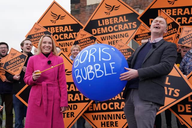 Newly elected Liberal Democrat MP Helen Morgan, bursts 'Boris' bubble' held by colleague Tim Farron, as she celebrates in Oswestry, Shropshire, following her victory in the North Shropshire by-election. Picture: PA