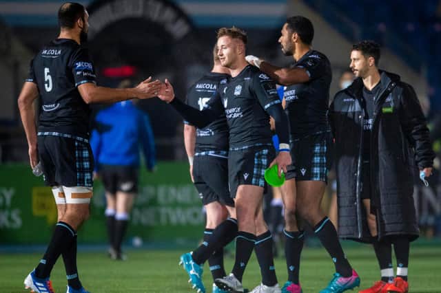 Glasgow's Brandon Thomson, centre, is consoled by team-mates at full time after his late conversion miss against the Dragons at Scotstoun. Picture: Ross MacDonald/SNS