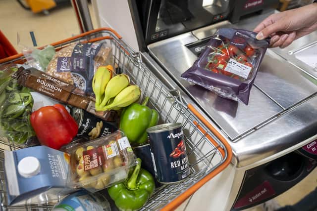 A woman scans groceries at a self service checkout in a supermarket. Picture: Matthew Horwood/Getty Images