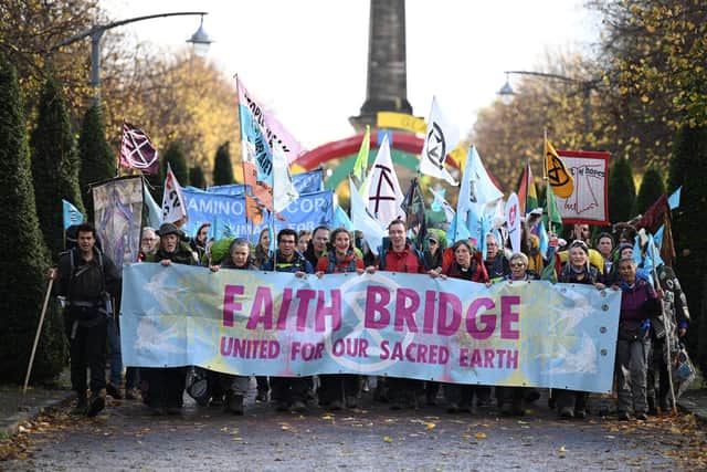 Demonstrators meet at Glasgow Green for the Pilgrims Procession, the opening event in a series of non-violent actions being organised by the Extinction Rebellion climate activist group during the COP26 climate summit