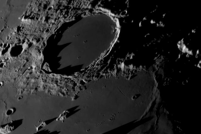 Runner-Up 
Sundown on the Terminator © Tom Williams
The Plato Crater is an almost perfectly circular crater that measures 109 km in diameter. This photograph was taken during a local lunar sunset in the last quarter, when approximately half of the Moon’s face is visible from Earth. The image captures dramatic shadows moving across the Moon.  
‘The best part of lunar astrophotography is that the Moon is one of the only objects in the night sky that can truly convey a feeling of three dimensions. Nowhere is this better presented than when the rising or setting Sun casts shadows across its mountains and craters. The sharpness and clarity of the shadows in this image are breathtaking. There is also a staggering amount of detail resolved in Plato Crater itself with many tiny craterlets visible, some of which are less than a kilometre in diameter. The ripples and waves in the ancient lava-filled maria surrounding the crater are also exquisitely captured, making this one of the finest examples of close-up lunar astrophotography that we have seen this year.’ - Steve Marsh
Taken with a Sky-Watcher 400P (16") GoTo Dobsonian Reflector telescope, Player One Uranus-C (IMX585) camera, 8,750 mm f/21.5,