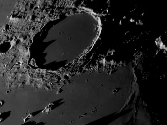 Runner-Up 
Sundown on the Terminator © Tom Williams
The Plato Crater is an almost perfectly circular crater that measures 109 km in diameter. This photograph was taken during a local lunar sunset in the last quarter, when approximately half of the Moon’s face is visible from Earth. The image captures dramatic shadows moving across the Moon.  
‘The best part of lunar astrophotography is that the Moon is one of the only objects in the night sky that can truly convey a feeling of three dimensions. Nowhere is this better presented than when the rising or setting Sun casts shadows across its mountains and craters. The sharpness and clarity of the shadows in this image are breathtaking. There is also a staggering amount of detail resolved in Plato Crater itself with many tiny craterlets visible, some of which are less than a kilometre in diameter. The ripples and waves in the ancient lava-filled maria surrounding the crater are also exquisitely captured, making this one of the finest examples of close-up lunar astrophotography that we have seen this year.’ - Steve Marsh
Taken with a Sky-Watcher 400P (16") GoTo Dobsonian Reflector telescope, Player One Uranus-C (IMX585) camera, 8,750 mm f/21.5,