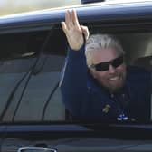 Richard Branson waves as he arrives at a base in Las Cruces, New Mexico