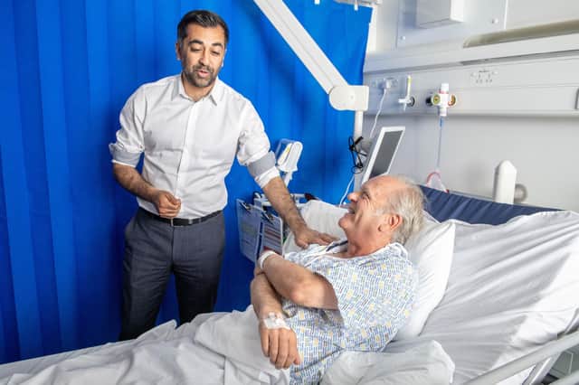 First Minister Humza Yousaf meets patient Paul MacIntosh during a visit to NHS Forth Valley Royal Hospital in Larbert, to mark the 75th anniversary of the NHS.