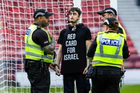 A protestor locked himself to the goal post in protest against Israel during a UEFA European Championship Quallifier between Scotland and Israel at Hampden Park. Photo: Craig Foy / SNS Group