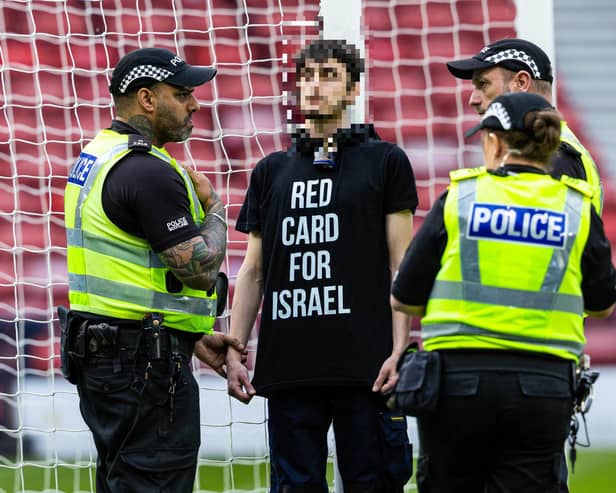 A protestor locked himself to the goal post in protest against Israel during a UEFA European Championship Quallifier between Scotland and Israel at Hampden Park. Photo: Craig Foy / SNS Group
