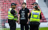 A protestor locked himself to the goal post in protest against Israel during a UEFA European Championship Quallifier between Scotland and Israel at Hampden Park. Photo: Craig Foy / SNS Group