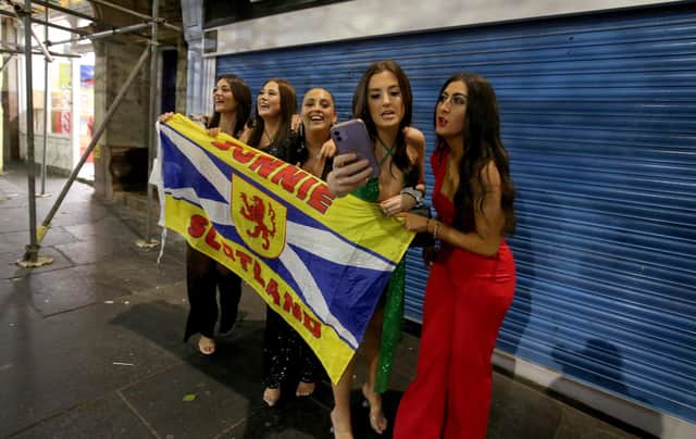 Revellers who travelled from Dundee take a selfie during Hogmanay celebrations in Newcastle, after street parties were banned in Scotland due to rising cases of coronavirus. Photo: Nigel Roddis/PA Wire