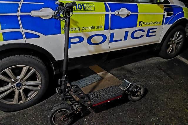 An e-scooter alongside a Police Scotland vehicle