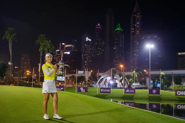 Australia's Minjee Lee lifts the trophy after winning the Omega Dubai Moonlight Classic at Emirates Golf Club. Picture: Tristan Jones