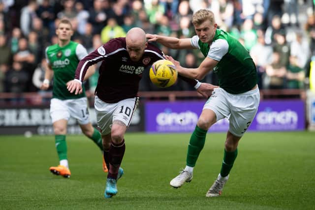 Liam Boyce and Josh Doig in action during a cinch Premiership match between Hearts and Hibs at Tynecastle.