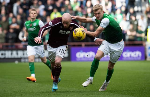 Liam Boyce and Josh Doig in action during a cinch Premiership match between Hearts and Hibs at Tynecastle.