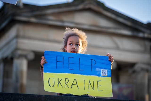 People gather for the Standing In Solidarity With Ukraine vigil on The Mound, Edinburgh, following the Russian invasion of Ukraine.