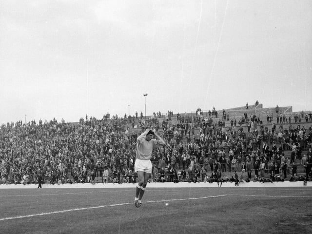 Outfield player Peter Cormack was forced to deputise in goal for the stricken goalie. He's pictured here with the old terraces in the background.