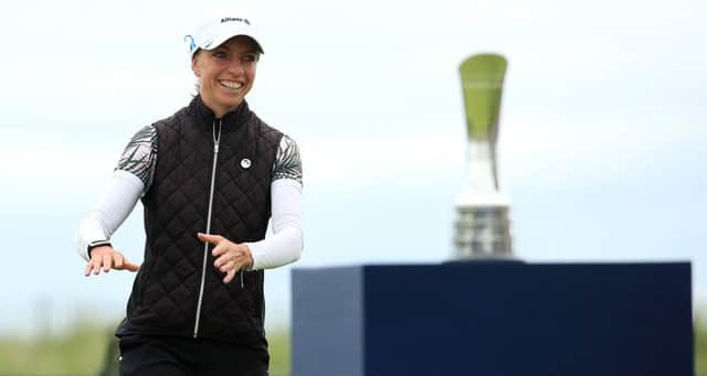 Sophia Popov walks forward to collect her trophy following her two-shot victory in the AIG Women’s Open. Picture: R&A via Getty.