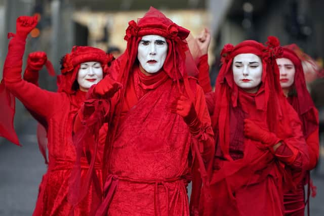 Extinction Rebellion 'Red Rebels' yesterday during the official final day of the Cop26 summit.