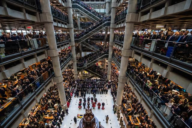 Employees line the balconies and escalators of the famous Lloyd's of London building during a service of Remembrance last year. Picture: Chris J Ratcliffe