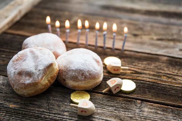 The Menorah candlestick holds nine candles, eight of which are lit using the ninth throughout Hanukkah.