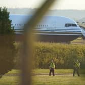 Police officers near a Boeing 767 aircraft at MoD Boscombe Down, near Salisbury, which is believed to be the plane set to take asylum seekers from the UK to Rwanda. Picture: Andrew Matthews/PA