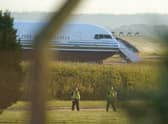 Police officers near a Boeing 767 aircraft at MoD Boscombe Down, near Salisbury, which is believed to be the plane set to take asylum seekers from the UK to Rwanda. Picture: Andrew Matthews/PA