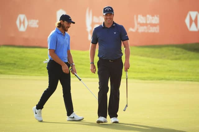 Marc Warren, right, smiles on the 18th green after finishing with a birdie in the Abu Dhabi HSBC Championship at Abu Dhabi Golf Club. Picture: Andrew Redington/Getty Images.