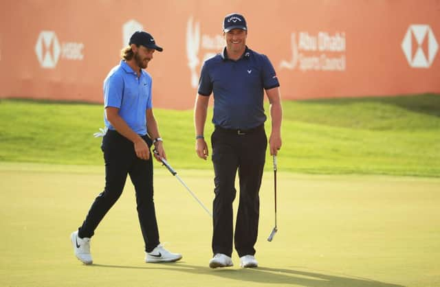 Marc Warren, right, smiles on the 18th green after finishing with a birdie in the Abu Dhabi HSBC Championship at Abu Dhabi Golf Club. Picture: Andrew Redington/Getty Images.