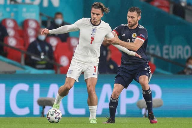 Stephen O'Donnell closely marked Jack Grealish. (Photo by CARL RECINE/POOL/AFP via Getty Images)