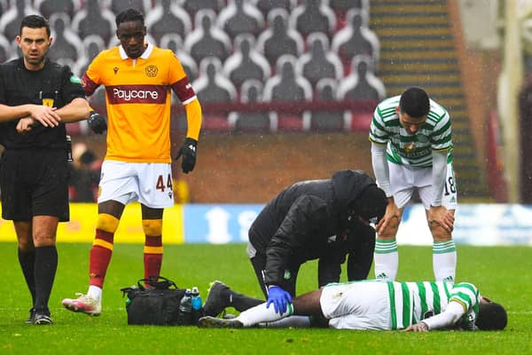 Celtic's Jeremie Frimpong is treated for an injury after a tackle from Devante Cole (left) during the away side's 4-1 win over Motherwell. Picture: SNS