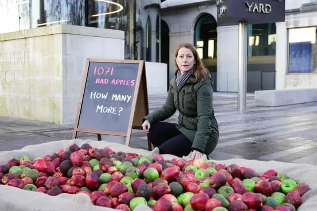 Refuge CEO, Ruth Davison, helps place 1,071 rotten apples outside New Scotland Yard, reflecting the number of Metropolitan Police officers who have been, or are currently, under investigation for allegations of domestic abuse or violence against women and girls . Aaron Chown/PA Wire