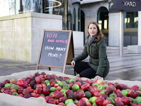Refuge CEO, Ruth Davison, helps place 1,071 rotten apples outside New Scotland Yard, reflecting the number of Metropolitan Police officers who have been, or are currently, under investigation for allegations of domestic abuse or violence against women and girls . Aaron Chown/PA Wire