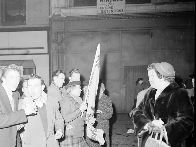 Reveller Wendy Wood with a Scottish flag on Edinburgh's High Street during Hogmanay celebrations in 1957.