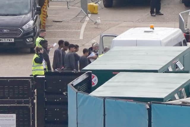 A group of migrants who arrived in the UK earlier this week are transported from the migrant reception compound in Dover, Kent. Picture: Gareth Fuller/PA Wire