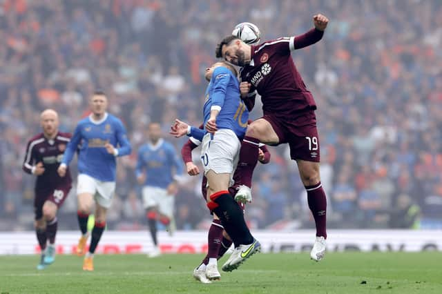 Steven Davis of Rangers battles for possession with Craig Halkett of Hearts.