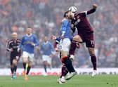 Steven Davis of Rangers battles for possession with Craig Halkett of Hearts.