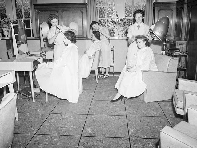 The hairdressers salon in Jenners could accommodate up to 10 clients. You can see three women here getting their hair done. Year: 1955