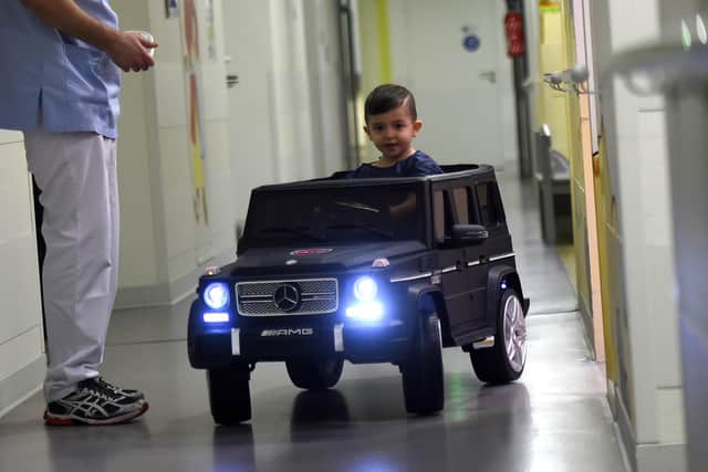 Electric toy cars let kids drive themselves to the operating theatre