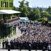 Spectators queue to enter the All England Tennis Club on the first day of the 2019 Wimbledon Championships.