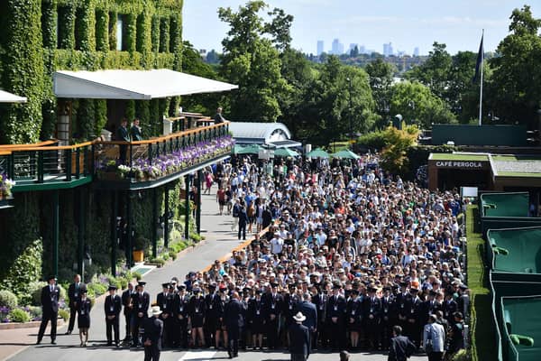 Spectators queue to enter the All England Tennis Club on the first day of the 2019 Wimbledon Championships.