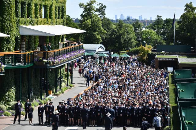 Spectators queue to enter the All England Tennis Club on the first day of the 2019 Wimbledon Championships.