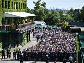 Spectators queue to enter the All England Tennis Club on the first day of the 2019 Wimbledon Championships.