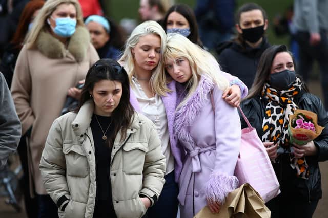 Two women embrace as they pay their respects on Clapham Common, where floral tributes have been placed for Sarah Everard. Picture: Hollie Adams/Getty Images
