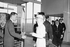 Queen Elizabeth II wears white overalls during a visit to Rothes Colliery, near Kirkcaldy, in June 1958.