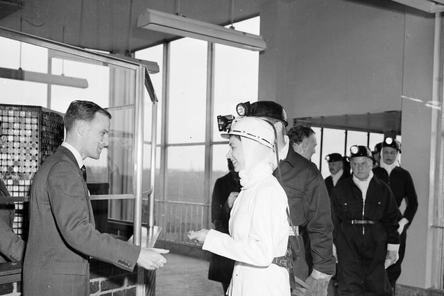 Queen Elizabeth II wears white overalls during a visit to Rothes Colliery, near Kirkcaldy, in June 1958.