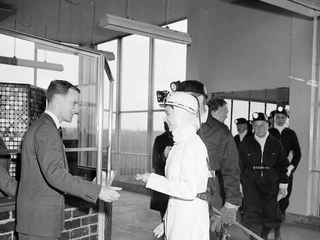 Queen Elizabeth II wears white overalls during a visit to Rothes Colliery, near Kirkcaldy, in June 1958.