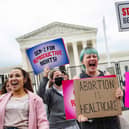Pro-choice demonstrators chant in front of un-scalable fence that stands around the US Supreme Court in Washington, DC, on May 5, 2022. (Photo by JIM WATSON/AFP via Getty Images)