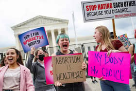Pro-choice demonstrators chant in front of un-scalable fence that stands around the US Supreme Court in Washington, DC, on May 5, 2022. (Photo by JIM WATSON/AFP via Getty Images)
