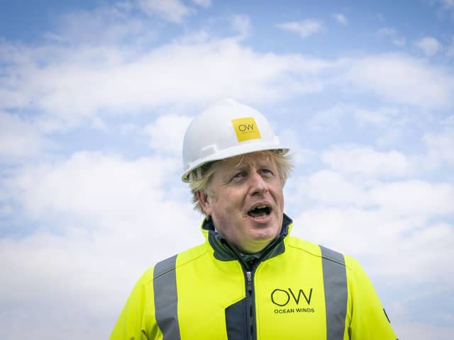 Britain's Prime Minister Boris Johnson speaks, onboard the Esvagt Alba during a visit to the Moray Offshore Windfarm East, off the Aberdeenshire coast, Scotland, Thursday, Aug. 5, 2021. (Jane Barlow/Pool Photo via AP)